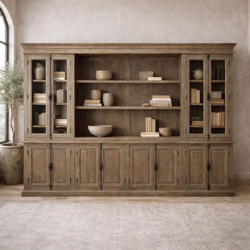 Gaston Grand Solid Wood Wall Unit Cabinet 2 A large wooden wall unit with glass cabinets and open shelving, styled with neutral books and ceramic decor in a bright, upscale living room.