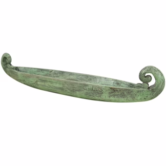 Angled view of green wooden boat shaped decorative tray with curved ends