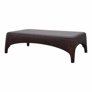 Three-quarter view of the Reeva coffee table with broad top, carved perimeter, softened corners, and sweeping arched base.